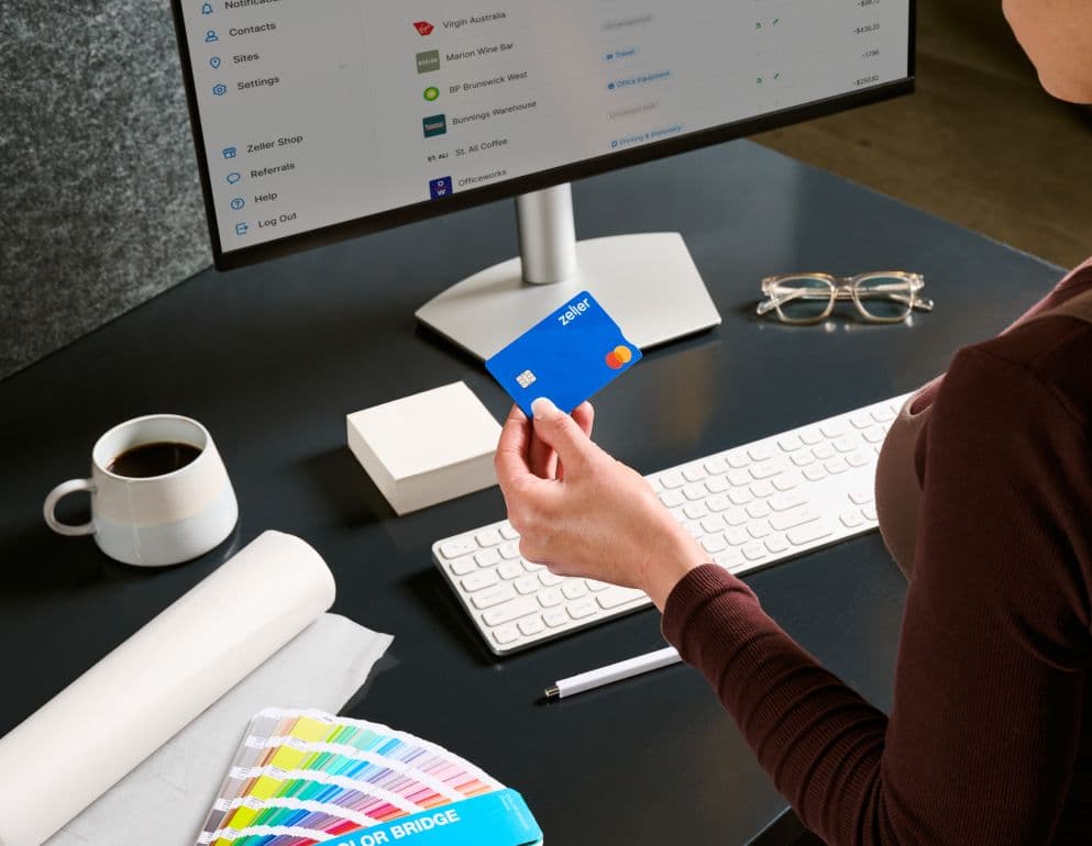Online invoices for freelancers - woman holding a blue Zeller Debit Card.