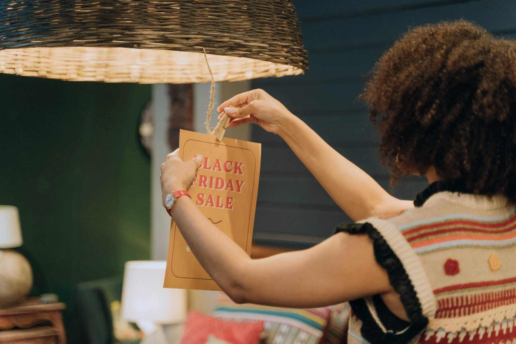 woman hanging Black Friday signage